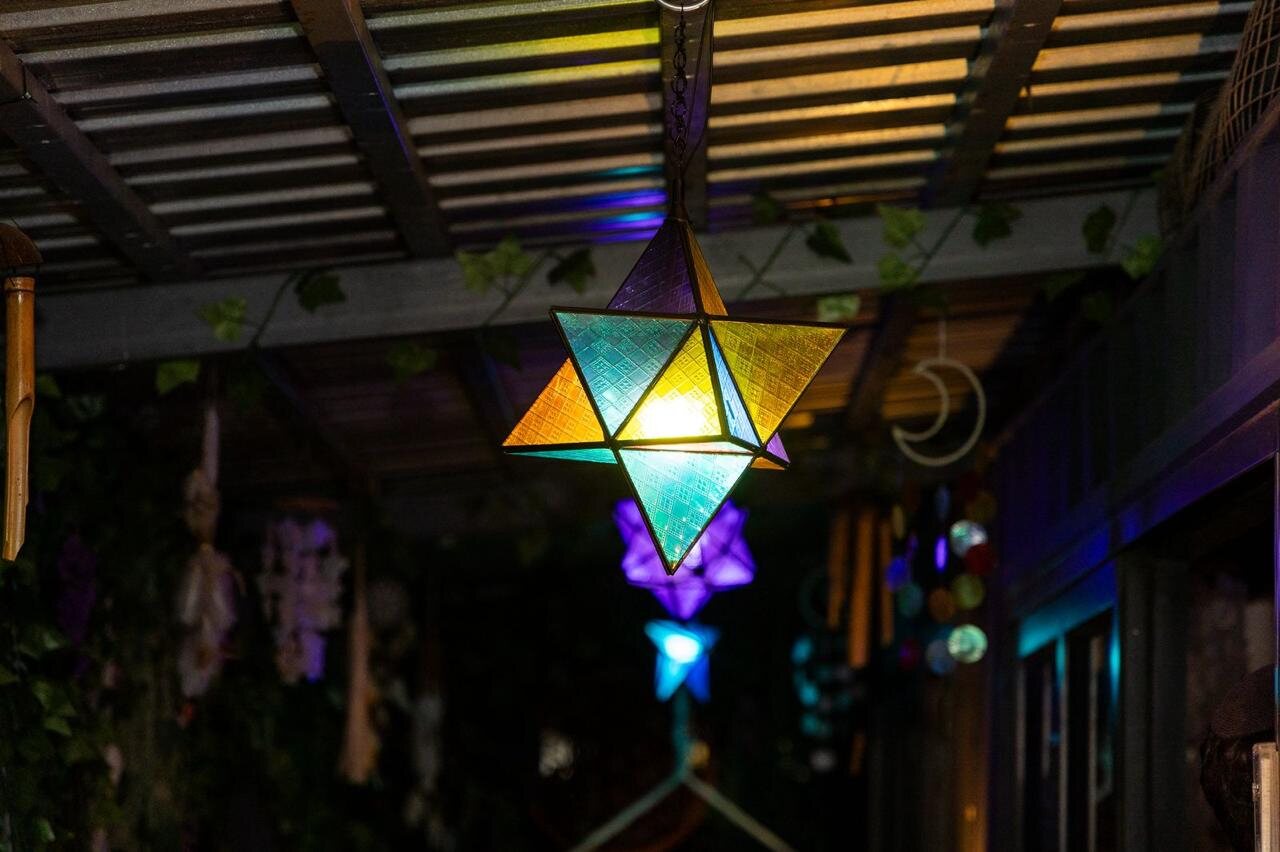 The HappiSpace patio at night with warm lighting, Fairmount
