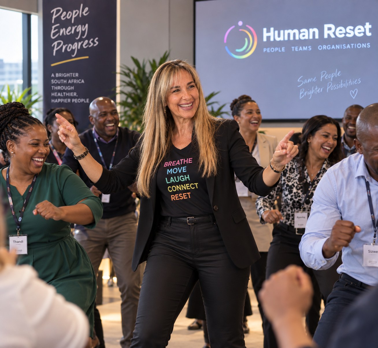 Corporate team laughing and reconnecting during a Human Reset session